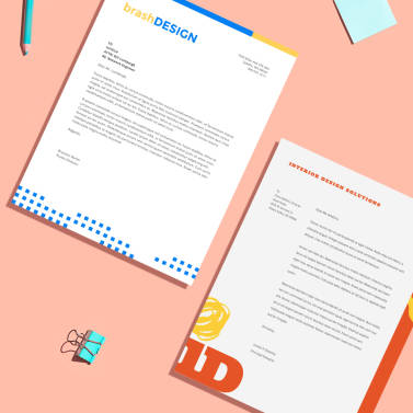 Colorful business letterhead design examples against a salmon-colored background.