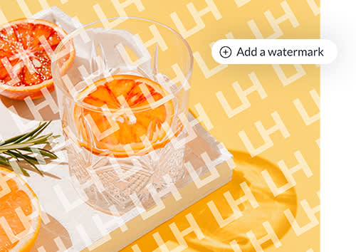 Watermark added to image of cocktail glass with sliced orange in it, along with text "Add a watermark" to highlight PicMonkey's new watermark tool.